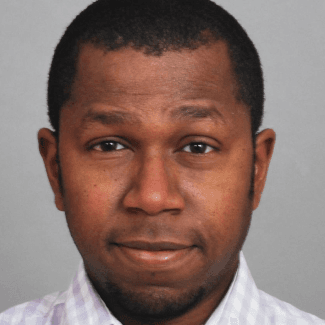 A professional headshot of Denicio Bute.